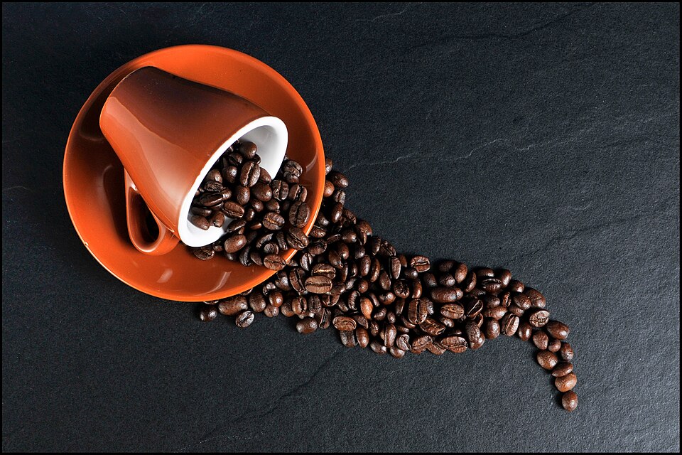 File:Coffee beans spilling out of a cup.jpg